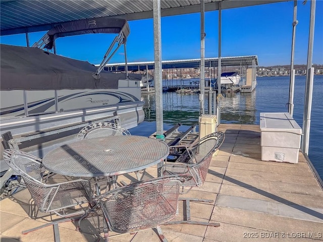 view of patio / terrace with a dock and a water view