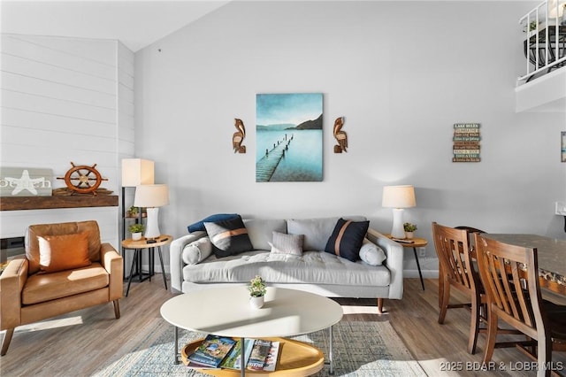 living room with vaulted ceiling and wood finished floors