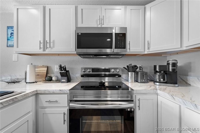 kitchen featuring appliances with stainless steel finishes and white cabinetry