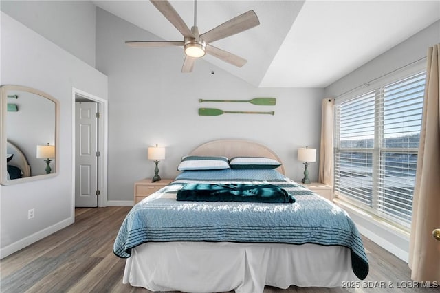 bedroom featuring lofted ceiling, a ceiling fan, baseboards, and wood finished floors