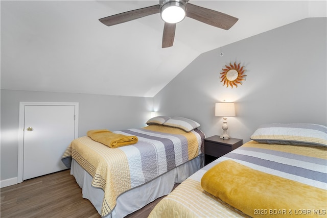 bedroom with vaulted ceiling, wood finished floors, and a ceiling fan