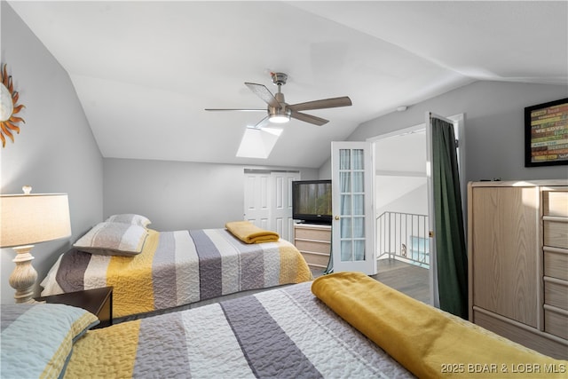 bedroom with ceiling fan, vaulted ceiling with skylight, a closet, and wood finished floors