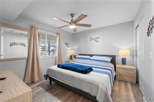 bedroom featuring light wood-style floors, a closet, and a ceiling fan