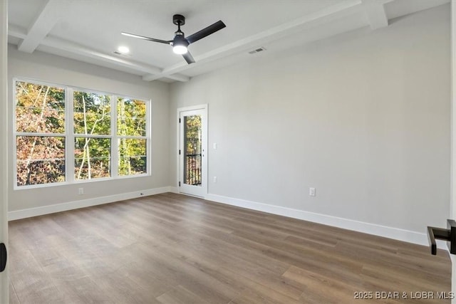 unfurnished room featuring hardwood / wood-style floors, ceiling fan, beam ceiling, and coffered ceiling