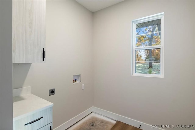 clothes washing area featuring hookup for an electric dryer, hookup for a washing machine, and cabinets