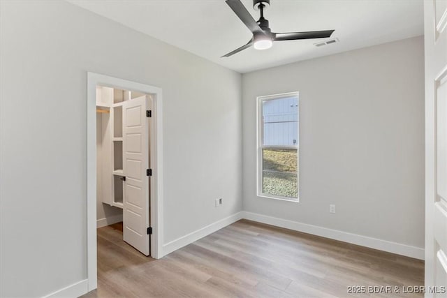 unfurnished bedroom with ceiling fan and light hardwood / wood-style flooring