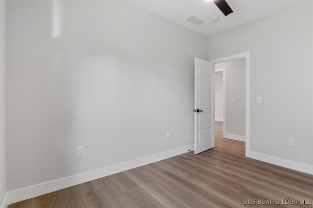 spare room with hardwood / wood-style flooring and ceiling fan