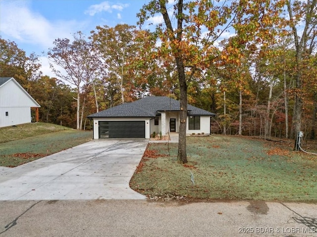 view of front of home featuring a garage and a front yard