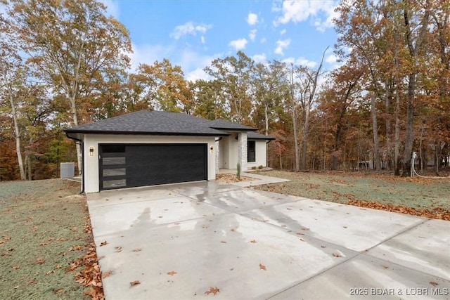 view of home's exterior featuring a garage, central AC unit, and a lawn