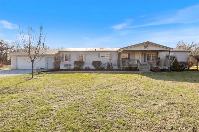 ranch-style home featuring covered porch, a front yard, and a garage