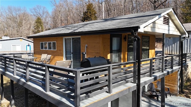 back of house featuring a wooden deck