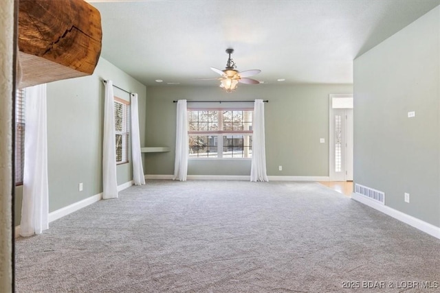 carpeted spare room featuring ceiling fan