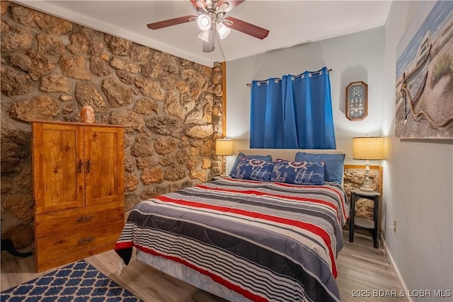 bedroom with ceiling fan and light hardwood / wood-style floors