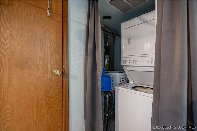 laundry area with stacked washer and dryer