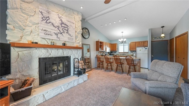 living room featuring high vaulted ceiling, a fireplace, beamed ceiling, a chandelier, and light carpet