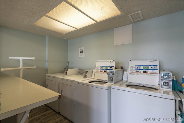 washroom featuring dark hardwood / wood-style floors and washer and clothes dryer