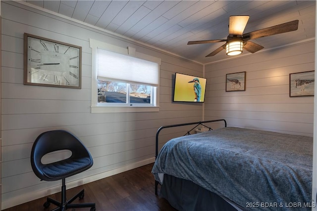 bedroom featuring wood walls, wooden ceiling, crown molding, ceiling fan, and dark hardwood / wood-style floors