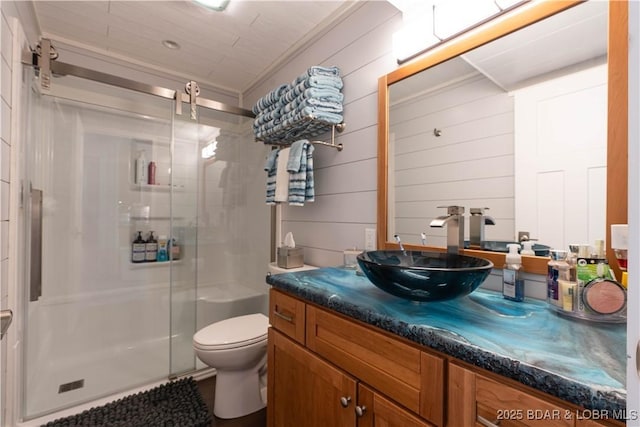 bathroom featuring walk in shower, ornamental molding, vanity, wooden walls, and toilet