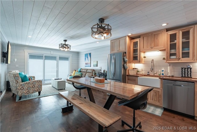 kitchen with hanging light fixtures, wood ceiling, sink, and appliances with stainless steel finishes