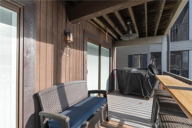 wooden terrace with grilling area and ceiling fan