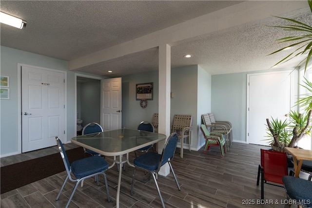 dining room with dark hardwood / wood-style flooring and a textured ceiling