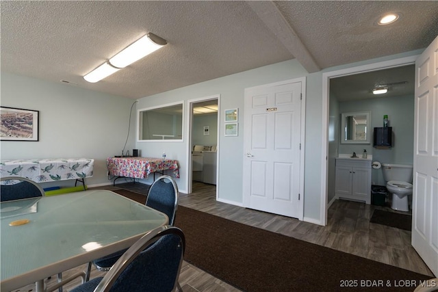 office area with a textured ceiling, washer / dryer, and dark wood-type flooring