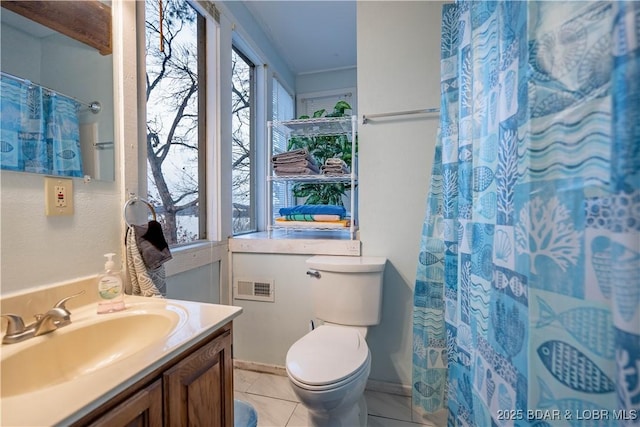 bathroom featuring tile patterned flooring, a shower with curtain, vanity, and toilet