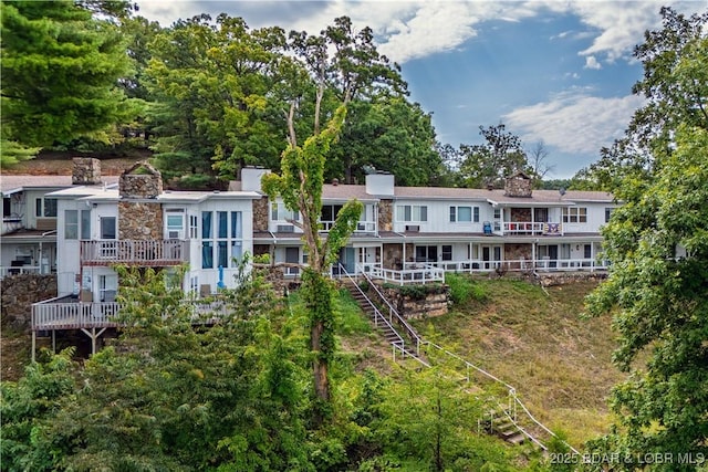 rear view of house featuring a deck