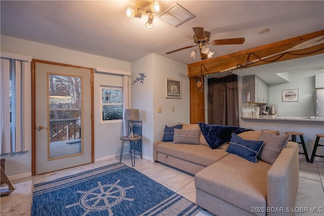 living room featuring ceiling fan and light tile patterned floors