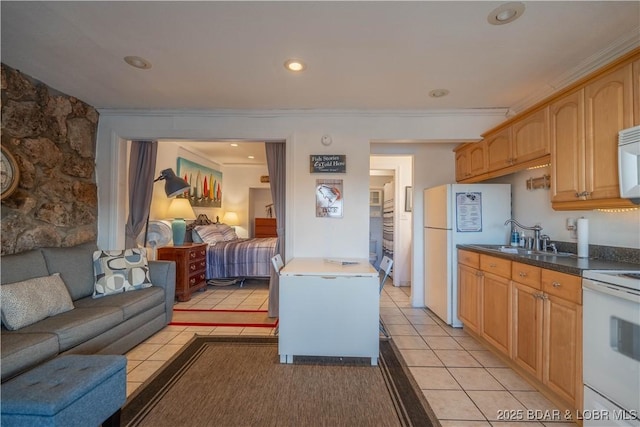 kitchen featuring light tile patterned floors, white appliances, crown molding, and sink