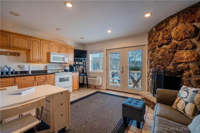 kitchen with light tile patterned flooring, white appliances, crown molding, and french doors