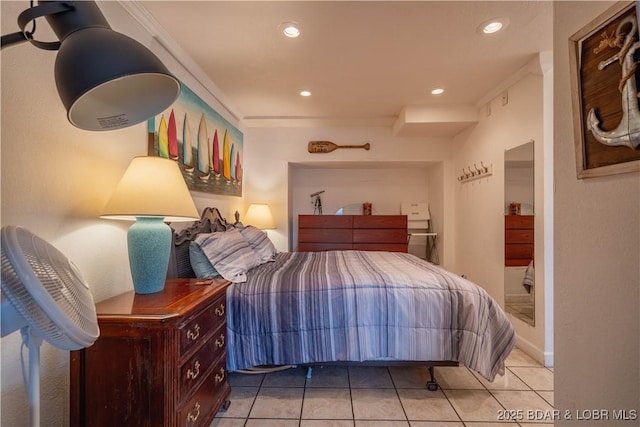 bedroom featuring light tile patterned floors and crown molding