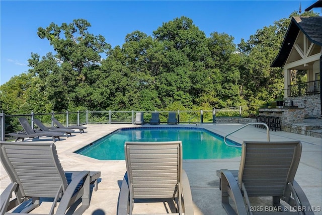 view of swimming pool with a bar and a patio