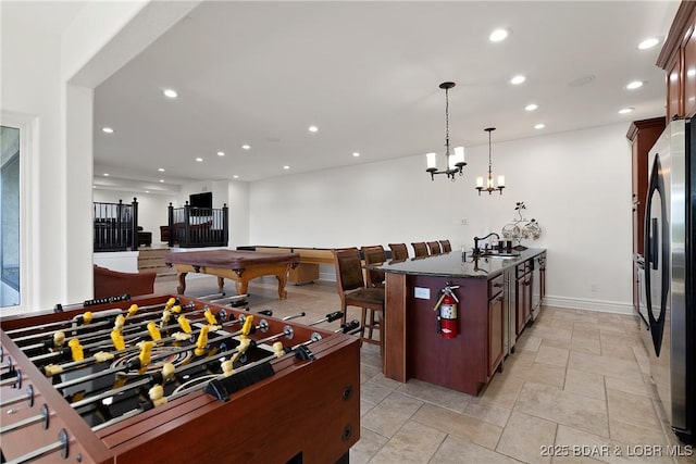 playroom featuring sink, a notable chandelier, and pool table