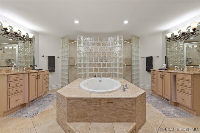 bathroom featuring tile patterned floors, plus walk in shower, vanity, and an inviting chandelier