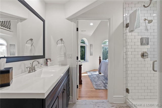 bathroom with lofted ceiling, vanity, and an enclosed shower