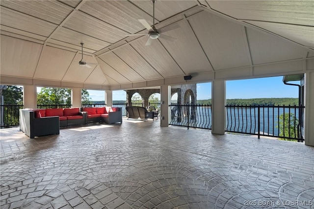 exterior space featuring ceiling fan, a water view, and an outdoor hangout area