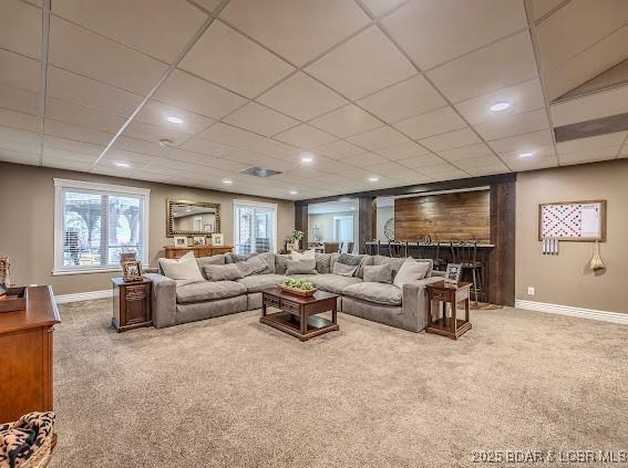 living room with carpet flooring and a fireplace