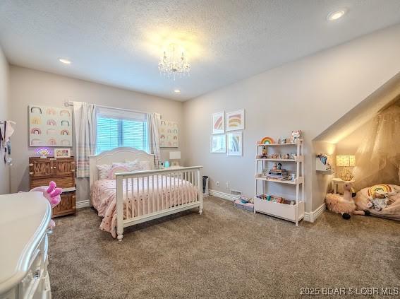 bedroom featuring carpet floors, a chandelier, and a textured ceiling