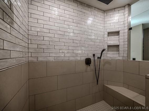 bathroom with a tile shower