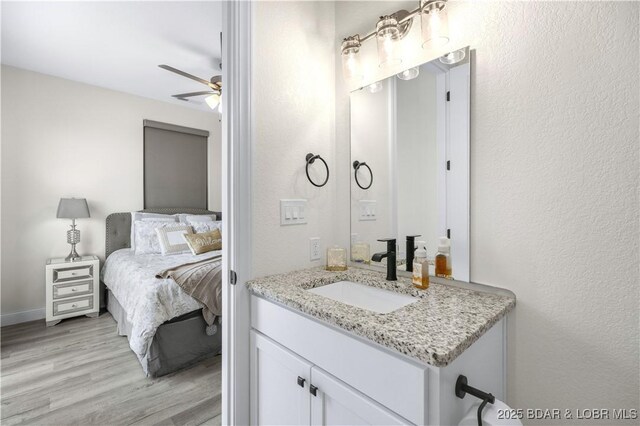 bathroom featuring vanity, hardwood / wood-style flooring, and ceiling fan