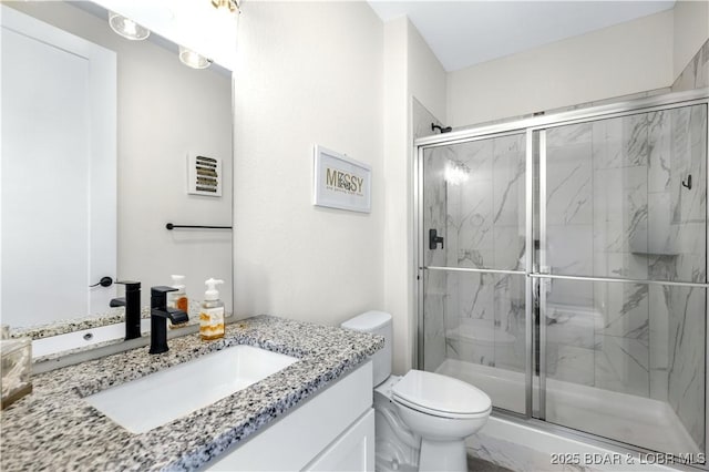 bathroom featuring vanity, toilet, and walk in shower