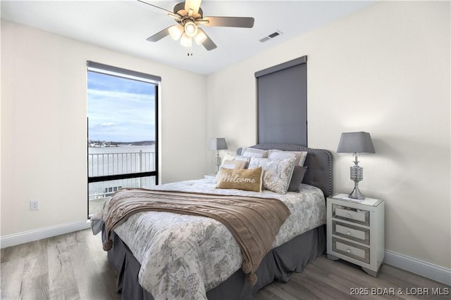 bedroom featuring hardwood / wood-style floors and ceiling fan