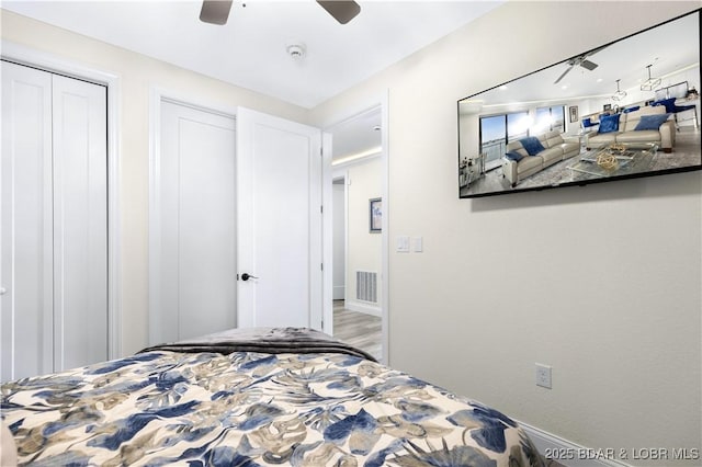 bedroom with ceiling fan and hardwood / wood-style flooring