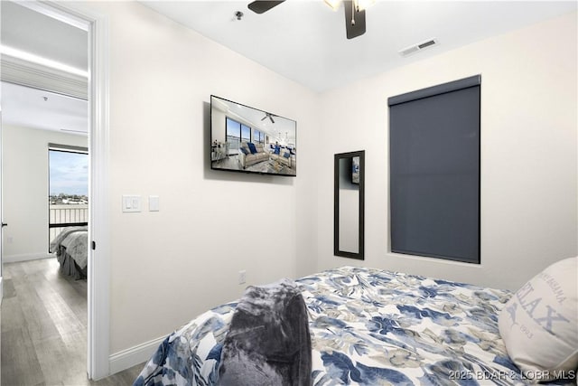 bedroom featuring hardwood / wood-style floors and ceiling fan