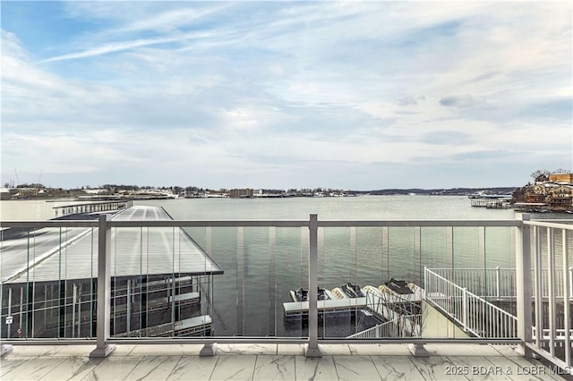 view of dock featuring a water view and a balcony