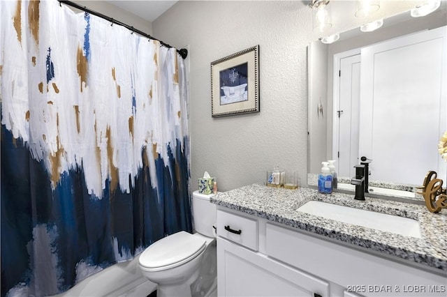 full bathroom with shower / tub combo with curtain, vanity, and toilet