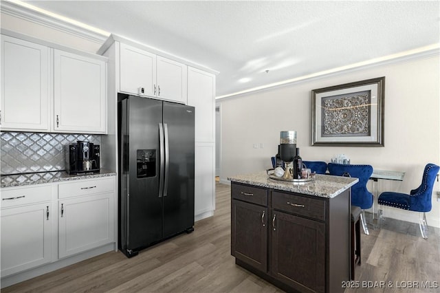 kitchen featuring white cabinetry, stainless steel fridge, tasteful backsplash, and light hardwood / wood-style floors