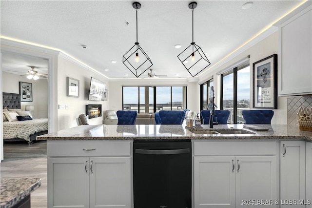 kitchen featuring ceiling fan, light stone countertops, white cabinetry, and black dishwasher