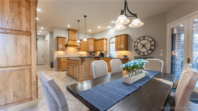 tiled dining room featuring an inviting chandelier